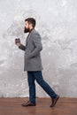 Brutal bearded hipster in denim wear. trendy man with beard. Modern life. Male fashion model. Mature businessman drink Royalty Free Stock Photo