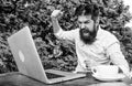 Brutal bearded hipster need coffee break. stressed man working on laptop. Frustrated office worker. aggressive Royalty Free Stock Photo
