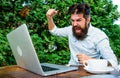 Brutal bearded hipster need coffee break. stressed man working on laptop. Frustrated office worker. aggressive