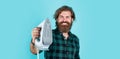 brutal bearded male man hold steaming iron, appliances Royalty Free Stock Photo