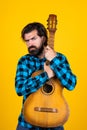 brutal bearded man with classical acoustic guitar, concept of country music Royalty Free Stock Photo