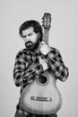 brutal bearded man with classical acoustic guitar, concept of country music Royalty Free Stock Photo