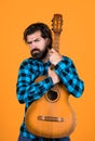 brutal bearded man with classical acoustic guitar, concept of country music Royalty Free Stock Photo