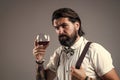 brutal bearded man hipster drinking wine, wine tasting Royalty Free Stock Photo