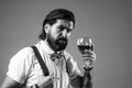 brutal bearded man hipster drinking wine, wine tasting Royalty Free Stock Photo