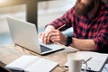 Brutal bearded man sitting at the table