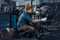 Mechanicl inspecting engine of a car in a garage.