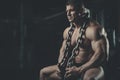 Brutal bodybuilder working out in gym with chain Royalty Free Stock Photo