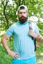 Brutal caucasian hipster with moustache. Bearded man carry backpack. ready for camping. male bearded tourist wear cap