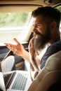 Brutal caucasian hipster with moustache. Male barber care. Mature hipster with beard. Taxi. traffic jam on road. time