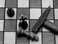 Brutal Checkmate: Hammer Next To A Defeated King On A Chess Board, Monochrome