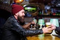 Brutal lonely hipster. Brutal hipster bearded man sit at bar counter. Friday evening. Bar is relaxing place to have Royalty Free Stock Photo