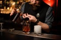 Bartender pouring an alcohol cocktail with jigger Royalty Free Stock Photo