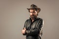 Brutal man cowboy hat leather jacket, confident person concept Royalty Free Stock Photo