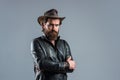 Brutal man cowboy hat leather jacket, confident person concept Royalty Free Stock Photo