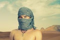 Brutal man in desert Royalty Free Stock Photo