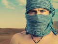 Brutal man in desert Royalty Free Stock Photo