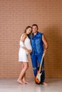 Brutal man with a guitar and a pregnant sweet woman of thirty years Royalty Free Stock Photo