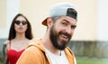 Brutal man with long beard and mustache. Hipster street fashion. Attractive guy in front of girl. Confident with his Royalty Free Stock Photo