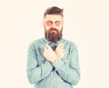 Brutal man in love. Blind from love. Hipster with paper red hearts and serious face. Bearded man holds symbols of Royalty Free Stock Photo