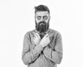 Brutal man in love. Blind from love. Hipster with paper red hearts and serious face. Bearded man holds symbols of Royalty Free Stock Photo