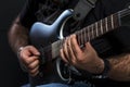 Brutal man's hands of the musician play the electric guitar. Hobby, passion and creativity. Close-up Royalty Free Stock Photo