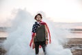 Brutal man wearing usa flag cape posing in white smoke Royalty Free Stock Photo