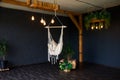 Brutal modern interior in a dark color with hammock. Loft style living room