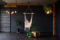 Brutal modern interior in a dark color with hammock. Loft style living room