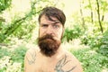 Brutal and rugged. Hairy hipster wearing long beard and mustache in brutal style. Bearded man with brutal look on summer