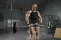 Brutal strong athletic men bodybuilder trains in the gym