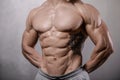 Brutal strong bodybuilder man posing in studio on grey background. Royalty Free Stock Photo