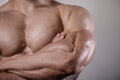 Brutal strong bodybuilder man posing in studio on grey background. Royalty Free Stock Photo