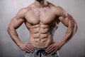 Brutal strong bodybuilder man posing in studio on grey background. Royalty Free Stock Photo