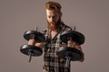 brutal strong man with dumbbells, determination. photo of brutal strong man with dumbbells.