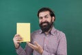 brutal unshaven guy university lecturer at chalkboard, library Royalty Free Stock Photo