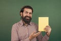 brutal unshaven guy university lecturer at chalkboard, library Royalty Free Stock Photo