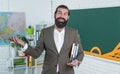 brutal unshaven guy university lecturer in classroom, education Royalty Free Stock Photo