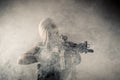 Brutal woman with gun in hands in smoke