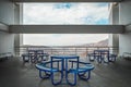 Brutalist concrete architecture, large space overlooking a ravine, blue dining benches. Beam framing the landscape Royalty Free Stock Photo