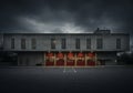A brutalist-style fire station with a stark, concrete facade features multiple vertical Royalty Free Stock Photo