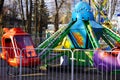 Bryansk, Russia - April 2022: a children`s attraction in the form of a carousel with booths in the form of a red helicopter, cars, Royalty Free Stock Photo