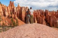 Bryce Canyon - Hugging couple with scenic aerial view of hoodoo sandstone rock formations on Queens Garden trail, Utah, USA Royalty Free Stock Photo