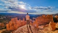 Bryce Canyon - Man in front of Thors Hammer during sunrise on Navajo Rim hiking trail Bryce Canyon National Park, Utah, USA Royalty Free Stock Photo