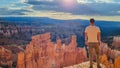 Bryce Canyon - Man in front of Thors Hammer during sunrise on Navajo Rim hiking trail Bryce Canyon National Park, Utah, USA Royalty Free Stock Photo