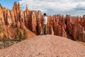 Bryce Canyon - Man with scenic aerial view of hoodoo sandstone rock formations on Queens Garden trail in Utah, USA