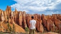 Bryce Canyon - Man with scenic aerial view of hoodoo sandstone rock formations on Queens Garden trail in Utah, USA