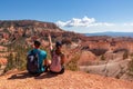 Bryce Canyon - Sitting couple with scenic aerial view from Fairyland hiking trail on massive hoodoo sandstone rock formations Royalty Free Stock Photo