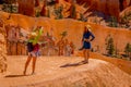 BRYCE CANYON, UTAH, JUNE, 07, 2018: Young Travelers taking pictures and standing on the cliff of Bryce Canyon National