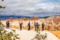 BRYCE CANYON, UTAH, USA - APRIL 2016: Group of hikers admiring a view of red sandstone hoodoos in Bryce Canyon National Park, USA